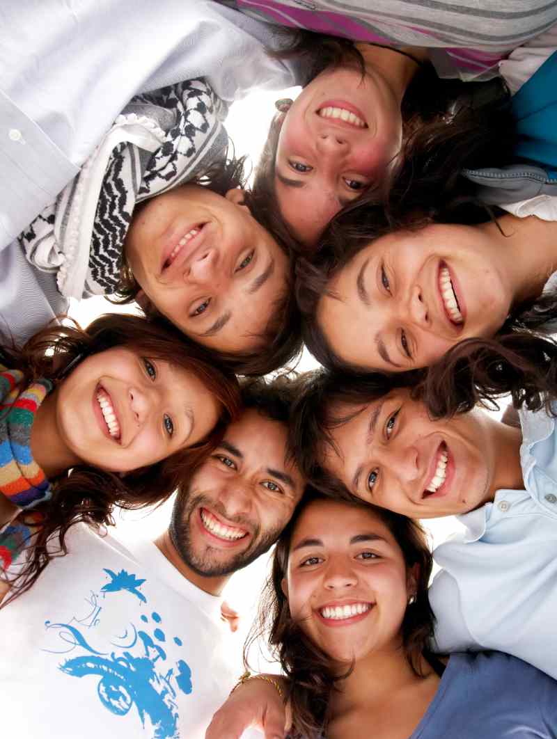 Casual Group Of Happy Young People Smiling Isolated Over A White Casual Group Of Happy Young People Smiling Isolated Over A White